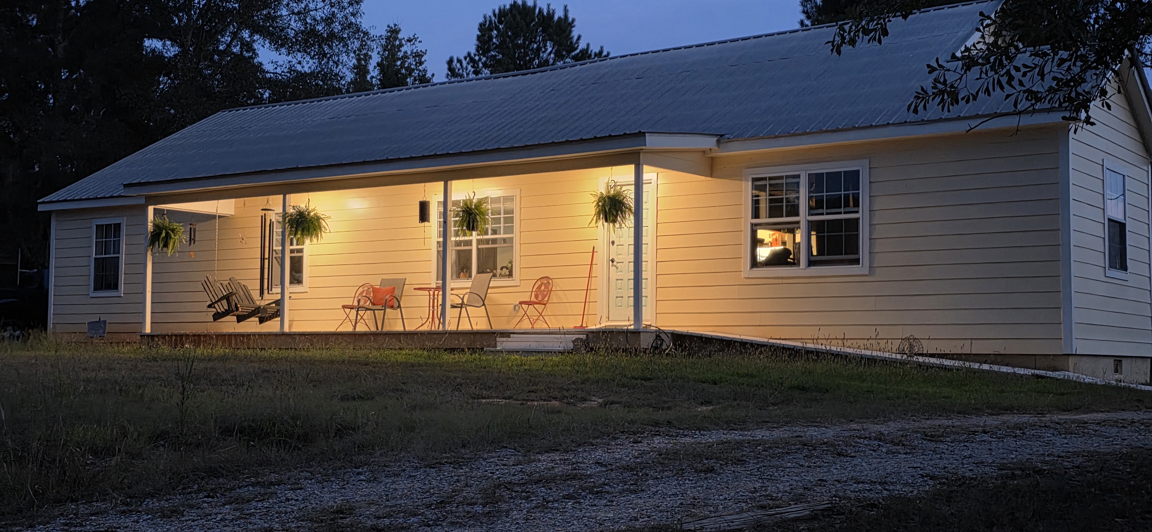 The Big House porch lit in the evening