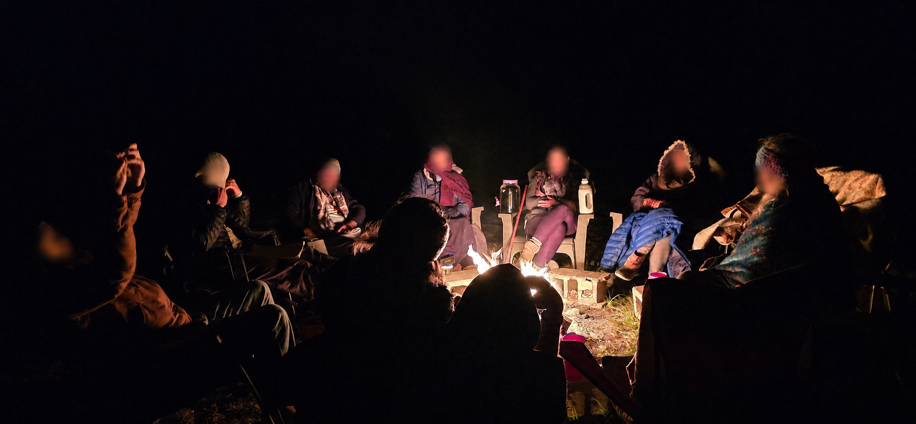 Group gathered around the night fire at The Pearl