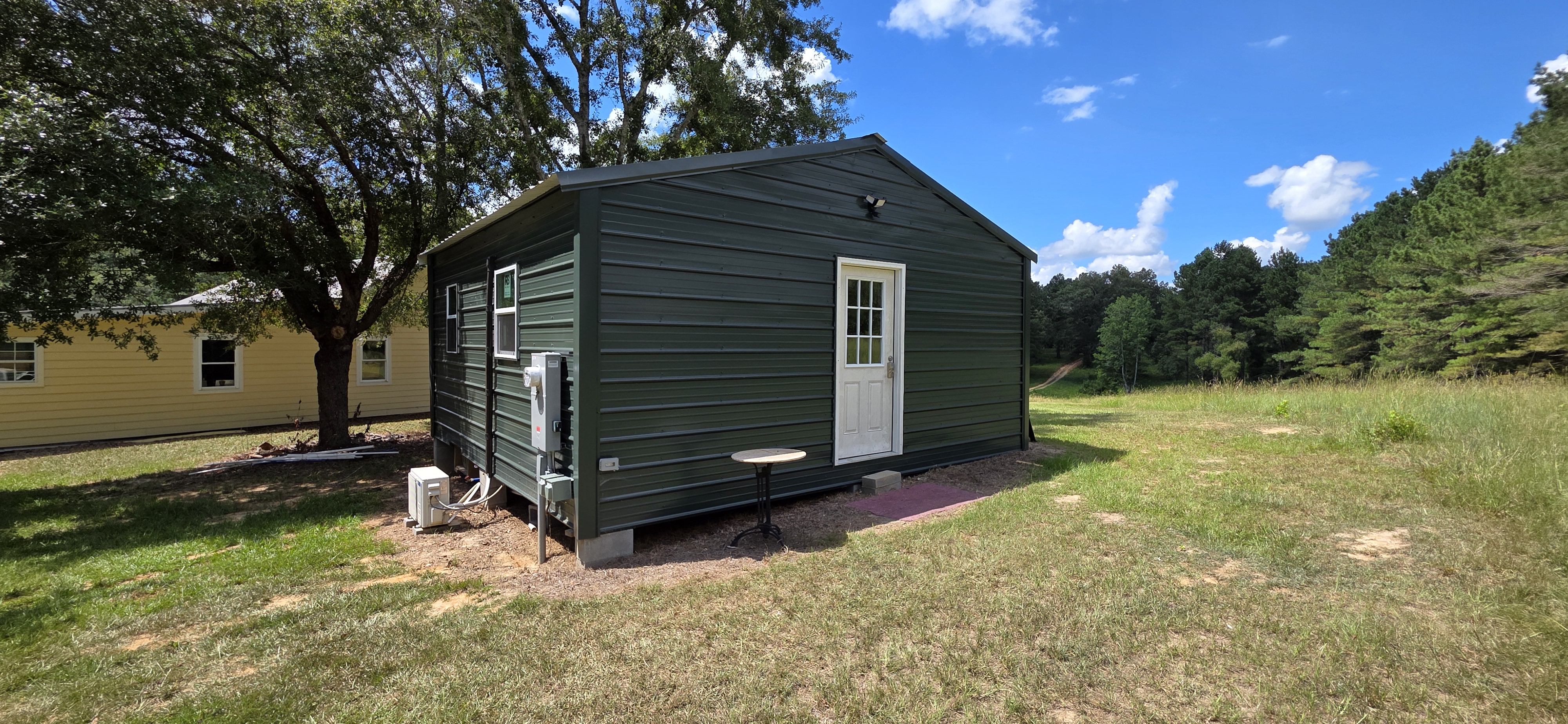 Current side view of the green tiny home at The Pearl
