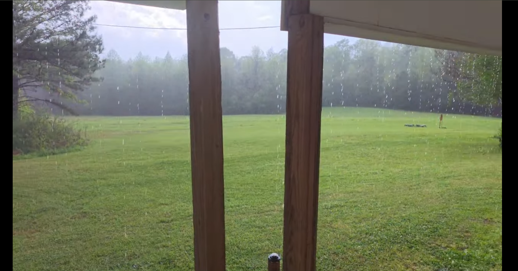 Rain falling across the field from the porch at The Pearl